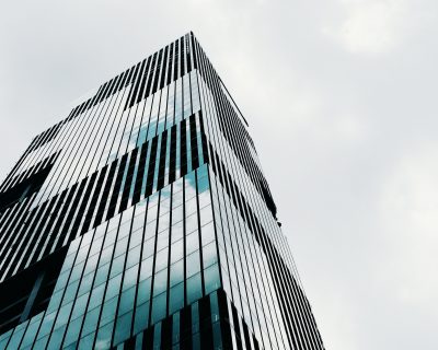 low-angle-shot-tall-high-rise-modern-business-building-with-clear-sky